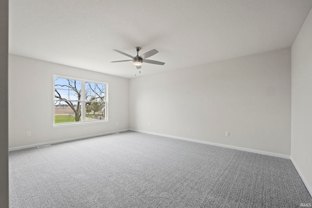 spare room featuring carpet floors and ceiling fan