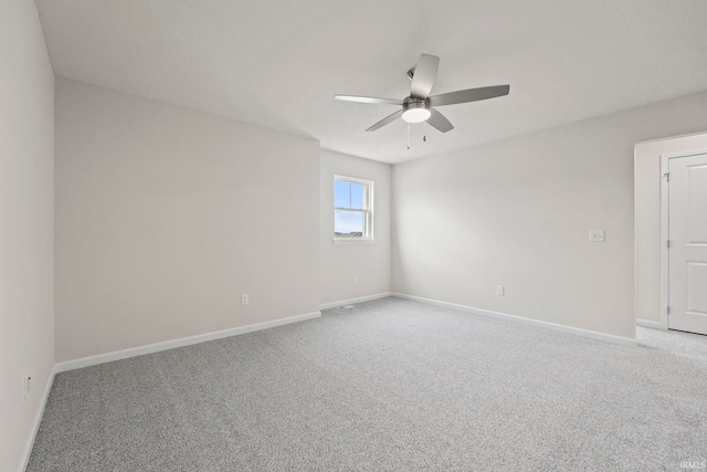 unfurnished room with ceiling fan and light carpet