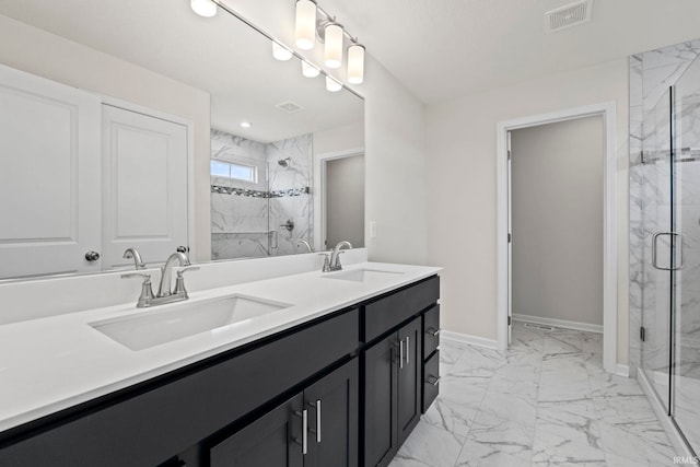 bathroom featuring tile flooring, dual vanity, and a shower with door