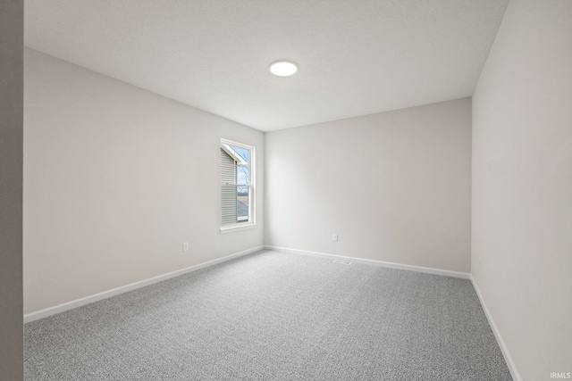 spare room with light colored carpet