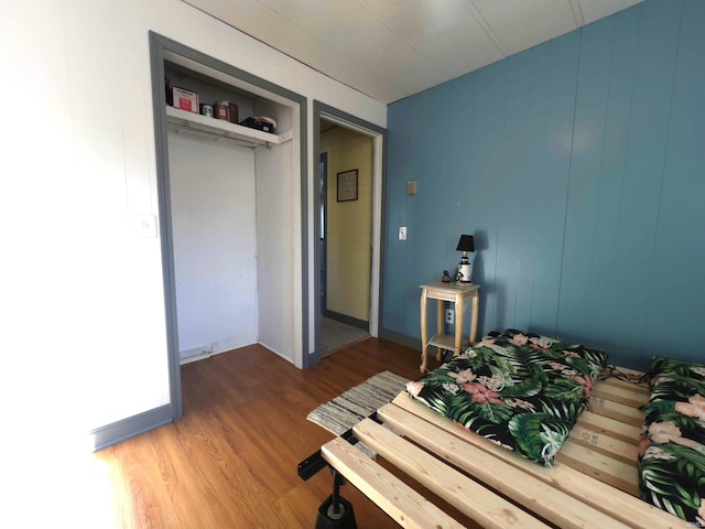 bedroom with a closet and hardwood / wood-style floors