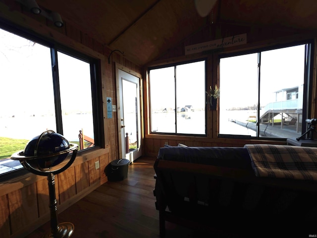 sunroom featuring plenty of natural light and vaulted ceiling