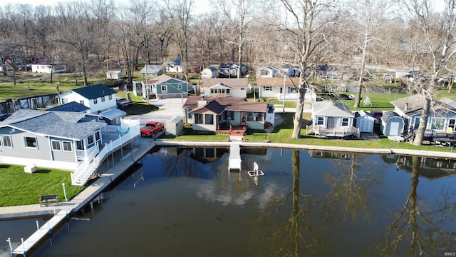 dock area with a water view and a lawn