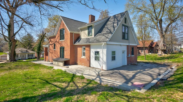 rear view of house featuring a yard