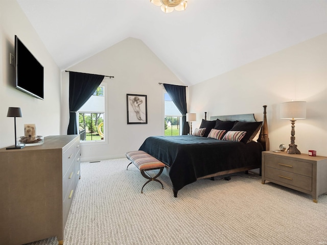 carpeted bedroom featuring multiple windows and lofted ceiling