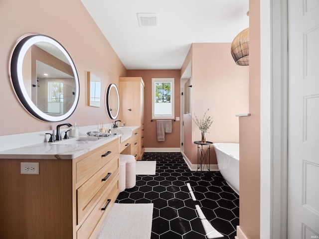 bathroom with a bathing tub, tile floors, and double vanity