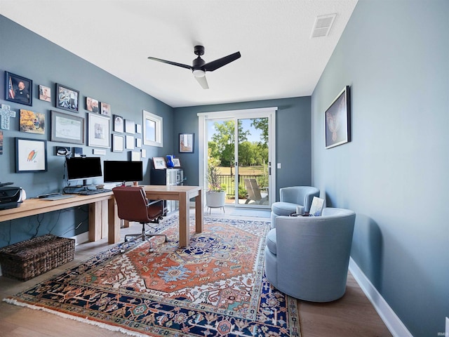 home office featuring hardwood / wood-style floors and ceiling fan