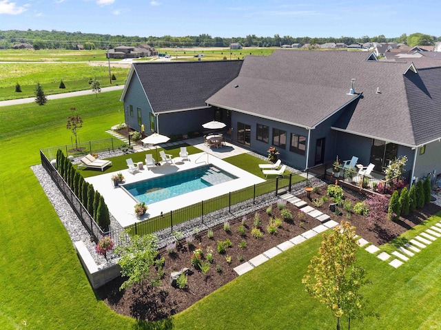 view of pool featuring a hot tub, a patio area, and a lawn