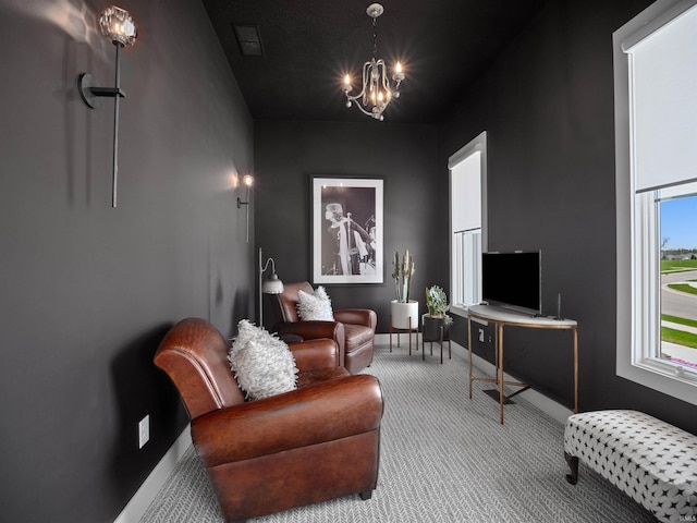 interior space featuring light carpet and a notable chandelier