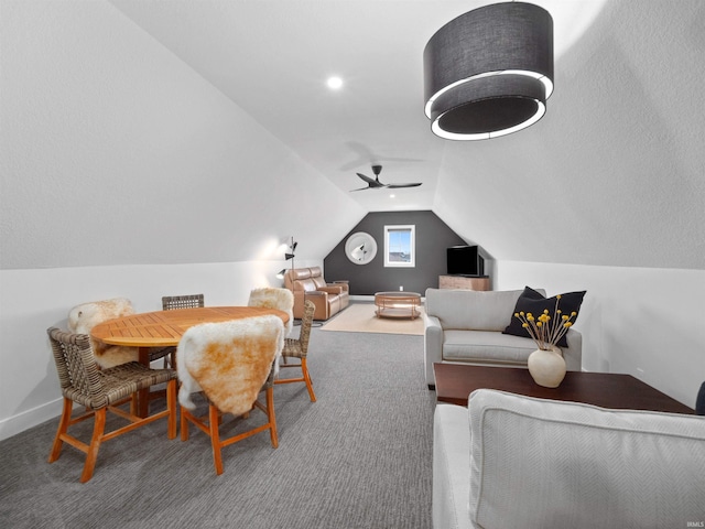 carpeted dining room featuring ceiling fan and vaulted ceiling