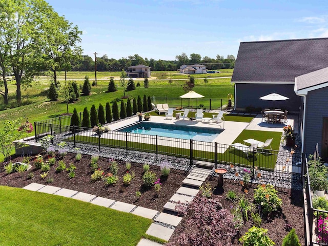 view of swimming pool with a patio area and a yard