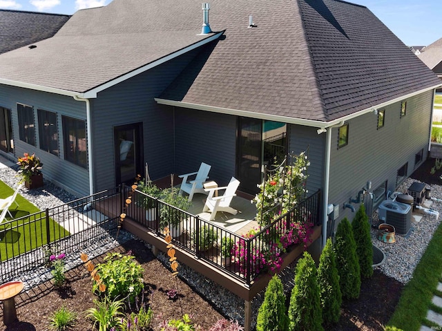 rear view of property with central AC unit