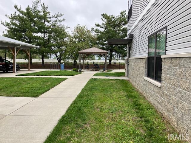 exterior space featuring a yard and a gazebo