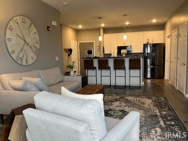 living room featuring dark wood-type flooring