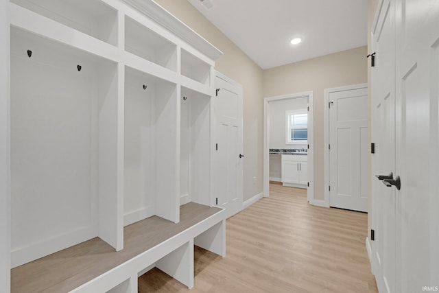 mudroom with light hardwood / wood-style floors