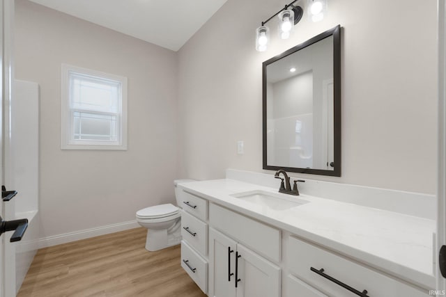 bathroom featuring a shower, toilet, vanity, and hardwood / wood-style flooring