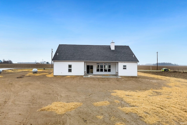 rear view of house with a rural view