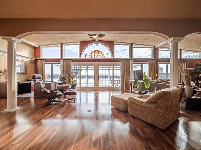 interior space with dark wood-type flooring and decorative columns