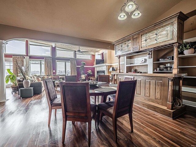 dining room with ceiling fan and dark hardwood / wood-style flooring