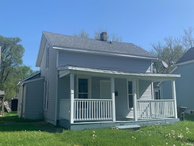 view of front of home featuring covered porch and a front yard