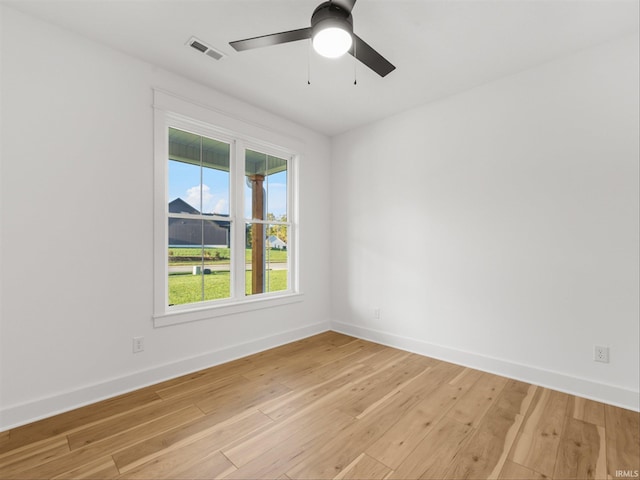 spare room with ceiling fan, a healthy amount of sunlight, and light hardwood / wood-style flooring