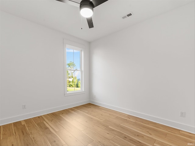 empty room with ceiling fan and light wood-type flooring