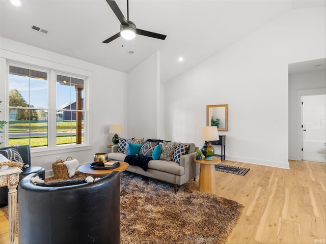 living room featuring ceiling fan, wood-type flooring, and lofted ceiling