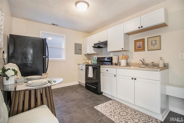 kitchen featuring white cabinetry, dark tile floors, black appliances, and sink