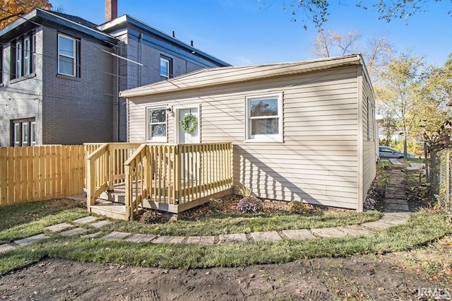 back of house featuring a wooden deck