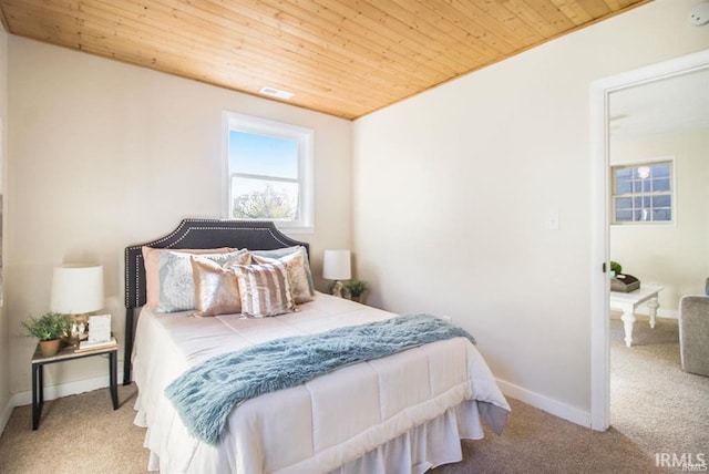 carpeted bedroom with wooden ceiling