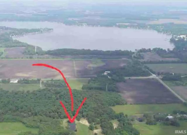 birds eye view of property with a rural view and a water view