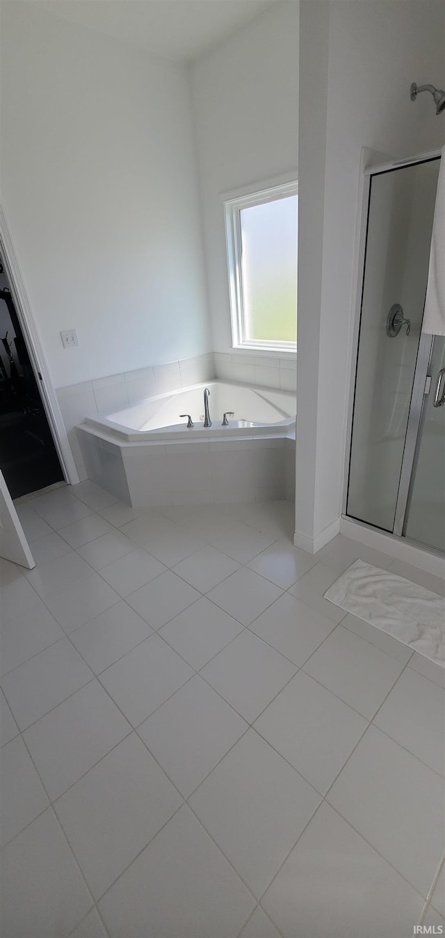 bathroom with tile patterned floors and separate shower and tub