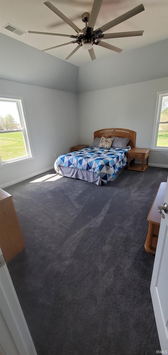 bedroom with ceiling fan and dark colored carpet