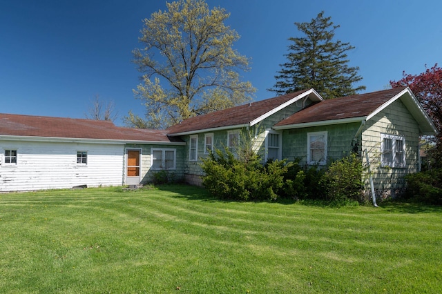 view of home's exterior with a lawn