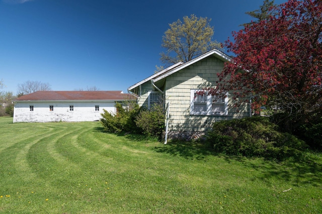 view of property exterior featuring a lawn