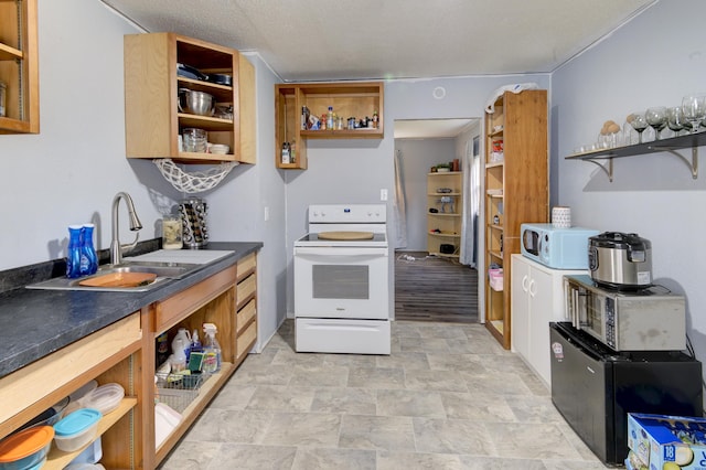 kitchen with sink, white appliances, a textured ceiling, and light tile patterned floors