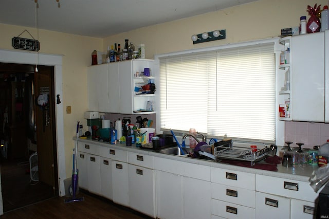 kitchen with white cabinets, sink, plenty of natural light, and dark hardwood / wood-style flooring