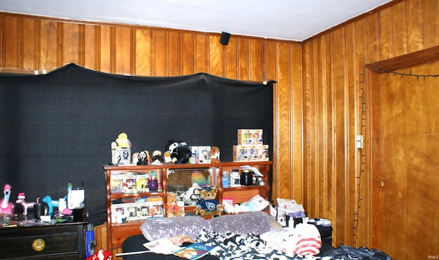 bedroom featuring wood walls