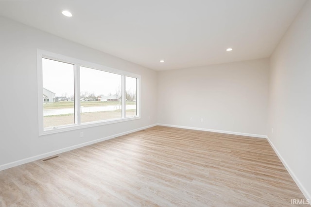 unfurnished room featuring light hardwood / wood-style floors