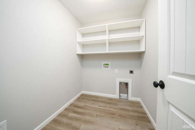 clothes washing area with hookup for a washing machine, light hardwood / wood-style flooring, and hookup for an electric dryer