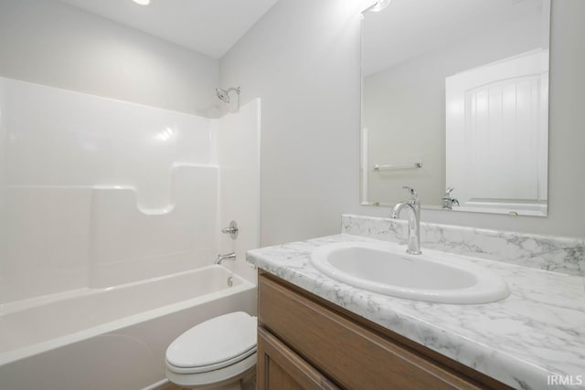 full bathroom featuring vanity, toilet, and  shower combination