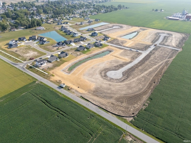 birds eye view of property with a water view and a rural view