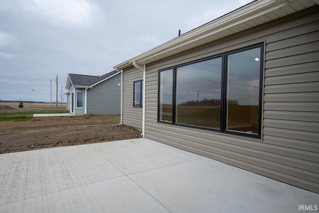 view of side of home featuring a patio area