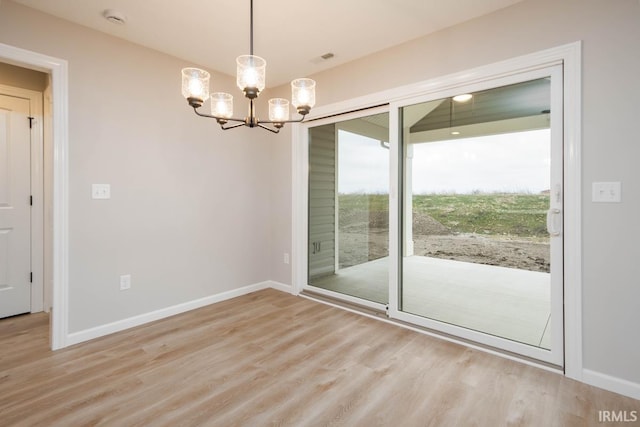 interior space featuring a notable chandelier and light wood-type flooring