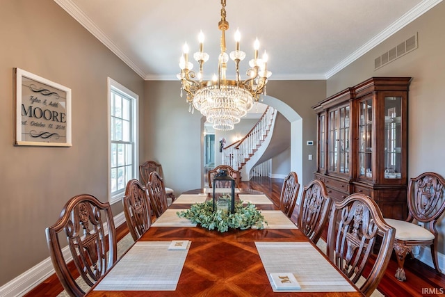 dining room featuring a chandelier, parquet floors, and crown molding