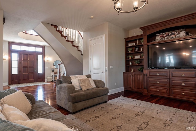 living room featuring wood-type flooring and a notable chandelier