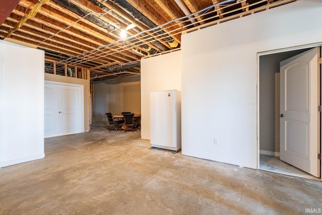 basement featuring white fridge