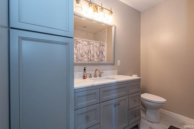 bathroom with vanity, toilet, and tile floors