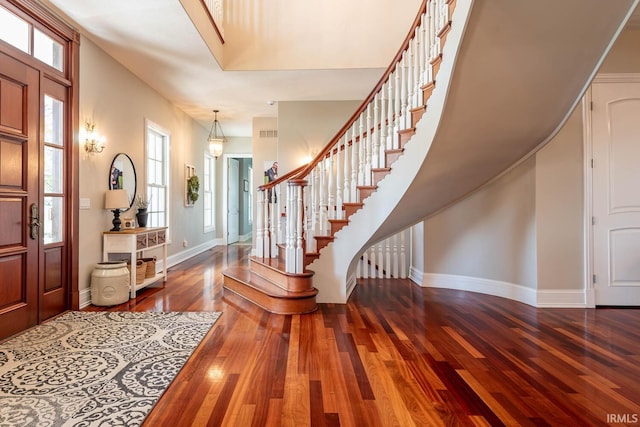 entryway with dark hardwood / wood-style flooring