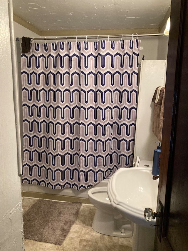 bathroom with toilet and tile flooring